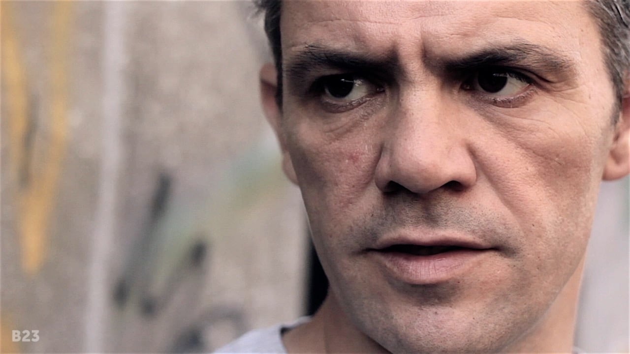 Big close-up of man with graffiti wall in the background