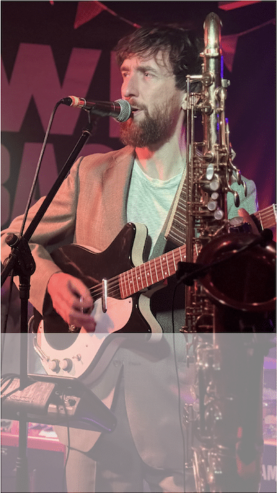 Man with guitar (singer from band Melin Melyn) with overlay on bottom third of image